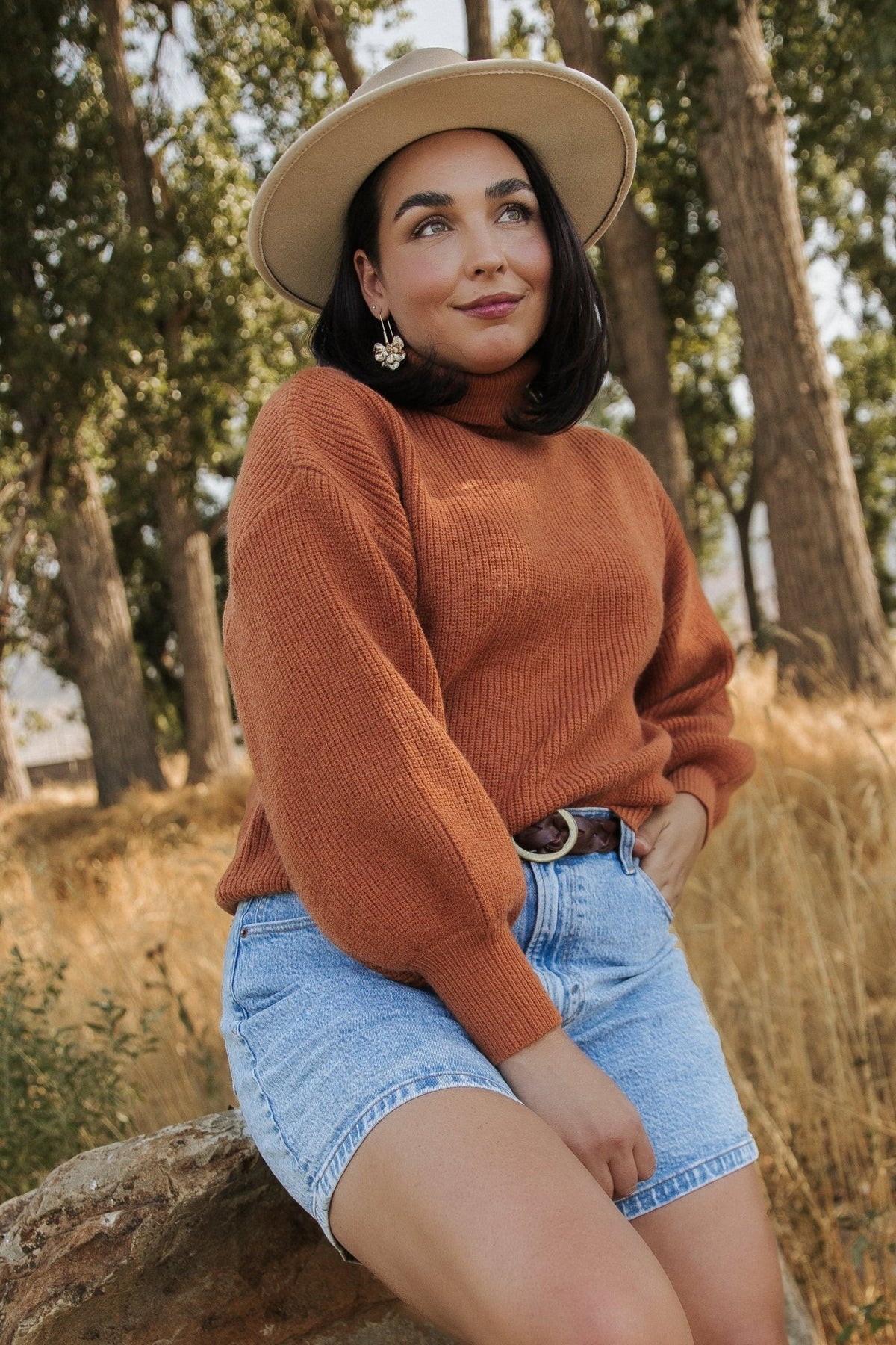 Styled outfit photo featuring spice ribbed turtleneck sweater paired with a skirt for an autumn-ready layered ensemble.