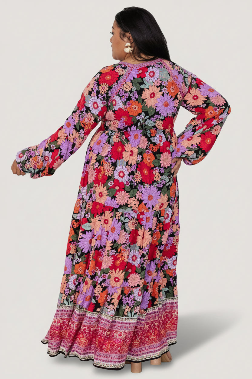 Flat-lay / studio view of Malena Tiered Maxi Dress in Black Multi, showing sleeve shape, elastic cuff and overall print.