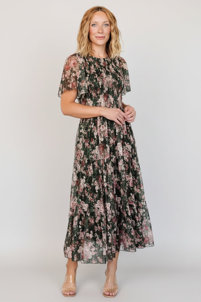 Back view showing round neckline and button-keyhole closure with delicate embroidery around the back and shoulder seams.