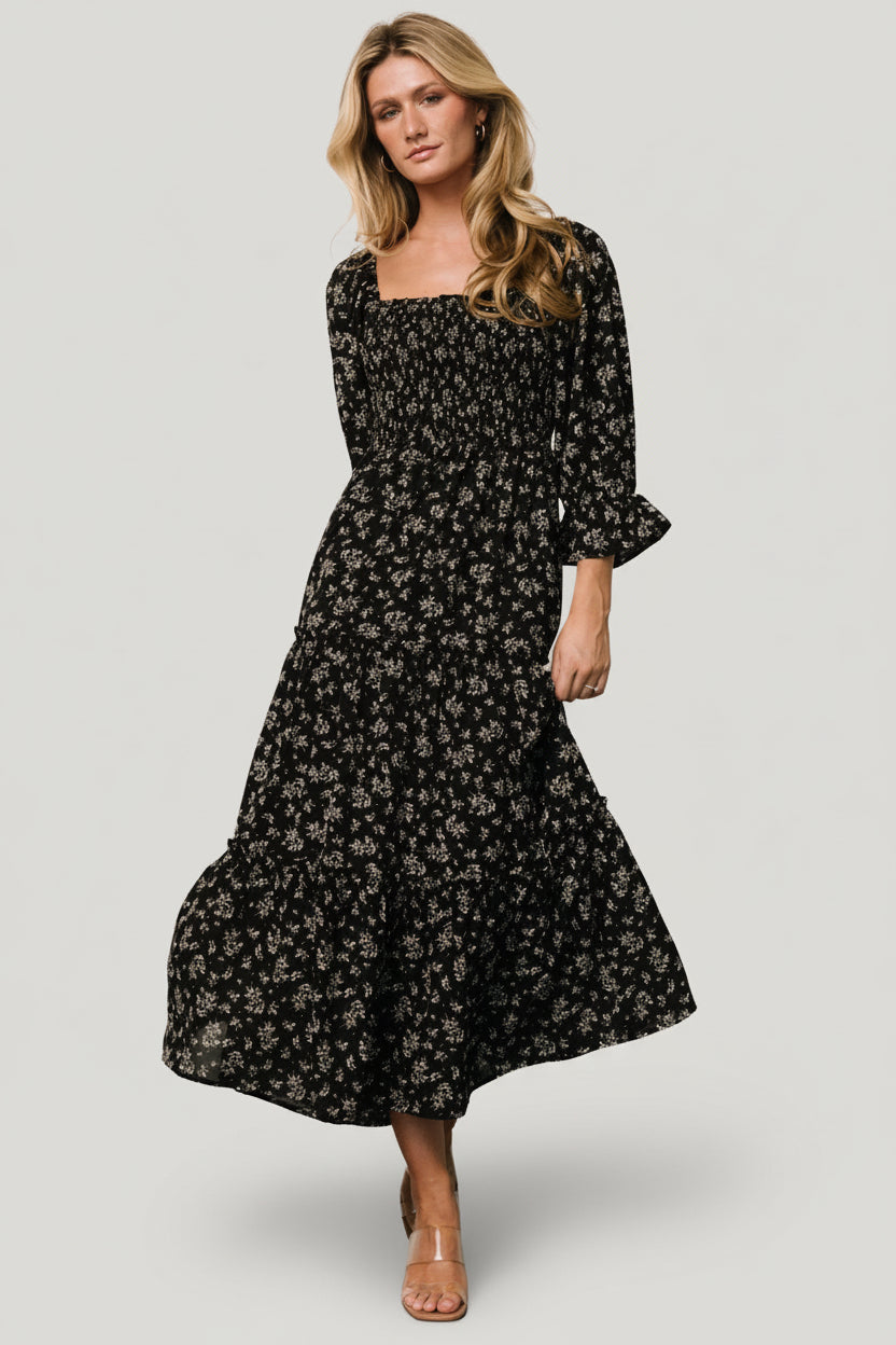 Back view of Margareta Tiered Midi Dress in black floral, showing gathered tiers and the fully lined skirt for comfortable wear.