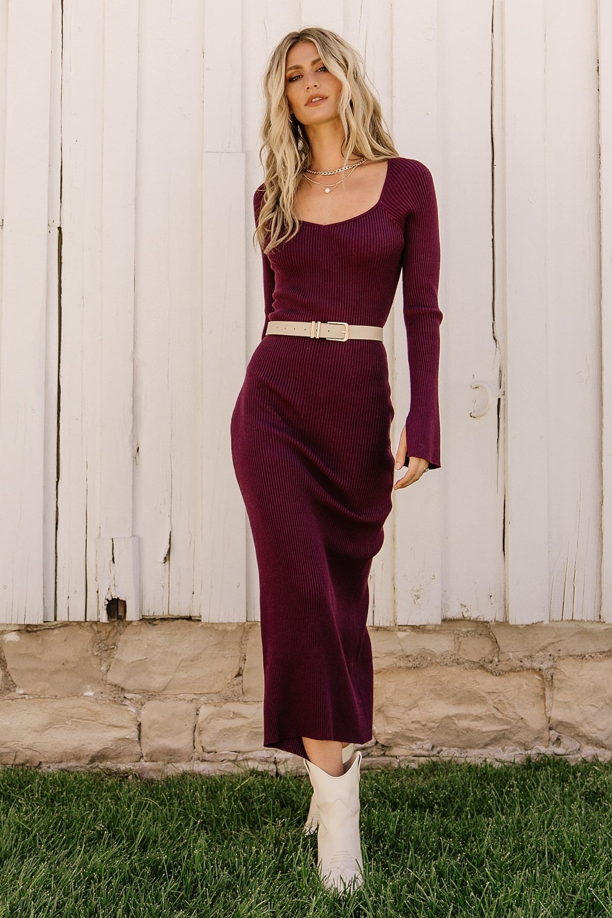 Side view of Marika Ribbed Midi Dress in merlot highlighting the close-to-body fit, knee-high center-back slit, and smooth drape of the fabric.