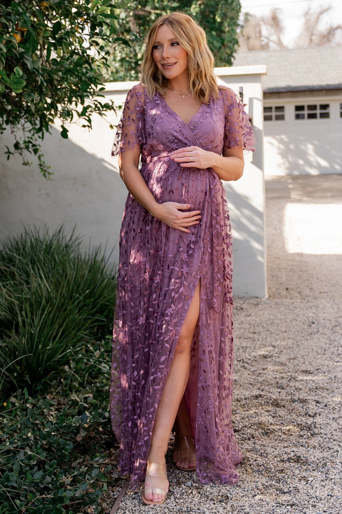 Back and side view of lavender Marseille embossed maxi dress with raw-cut hemline, flowing skirt, and separate waist tie.