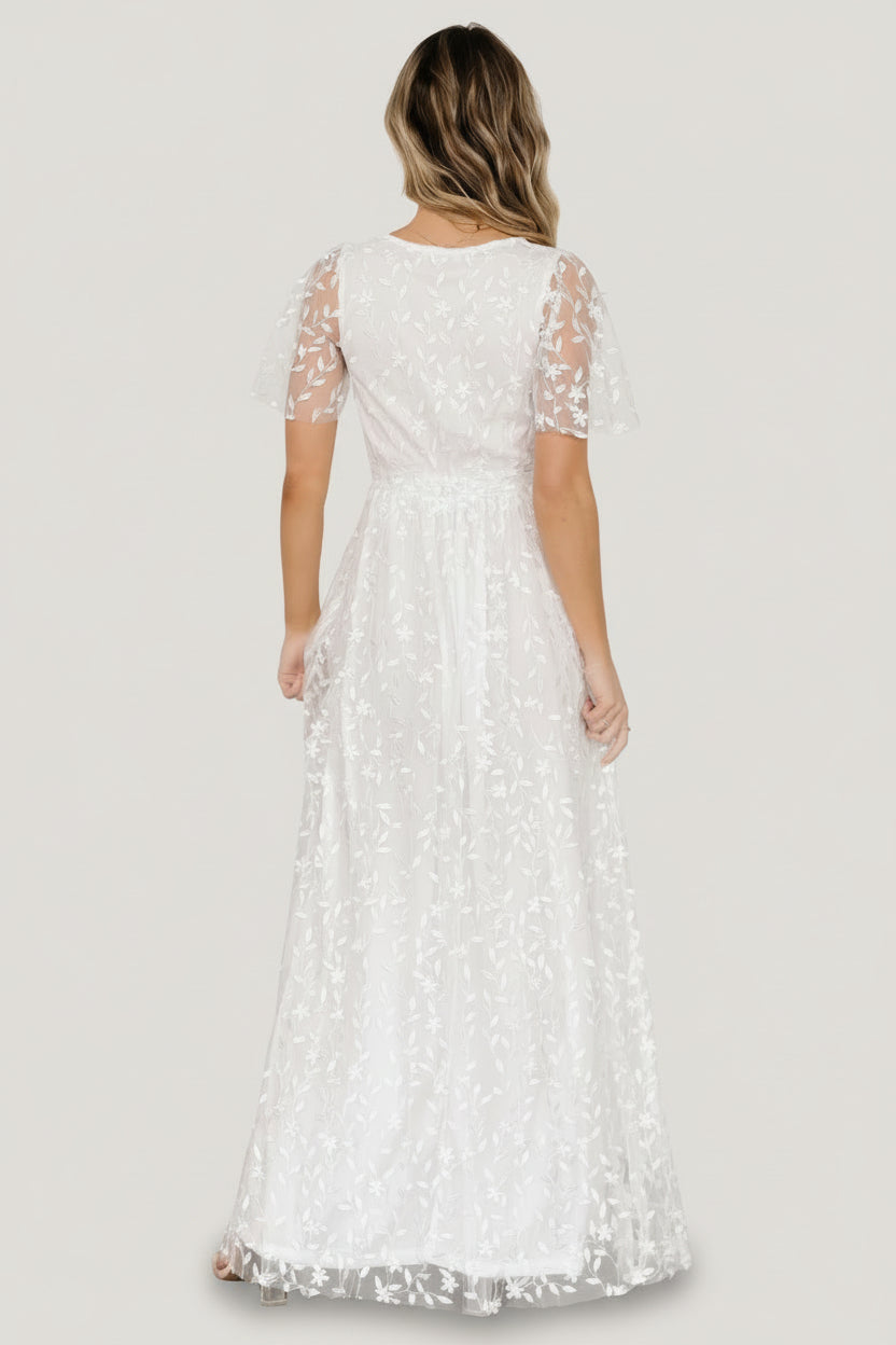 Back view of Marseille vine-embossed organza maxi dress in white, illustrating full lining, inverted seam detail, and the silhouette at the waist.