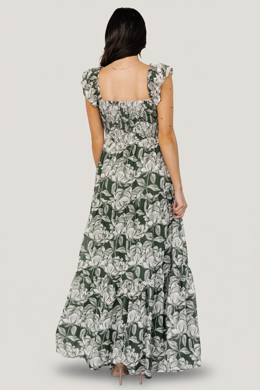 Side view of Martina Maxi Dress in green and white floral chiffon showing double-layered flutter sleeve and ruffle-tier details on the skirt.