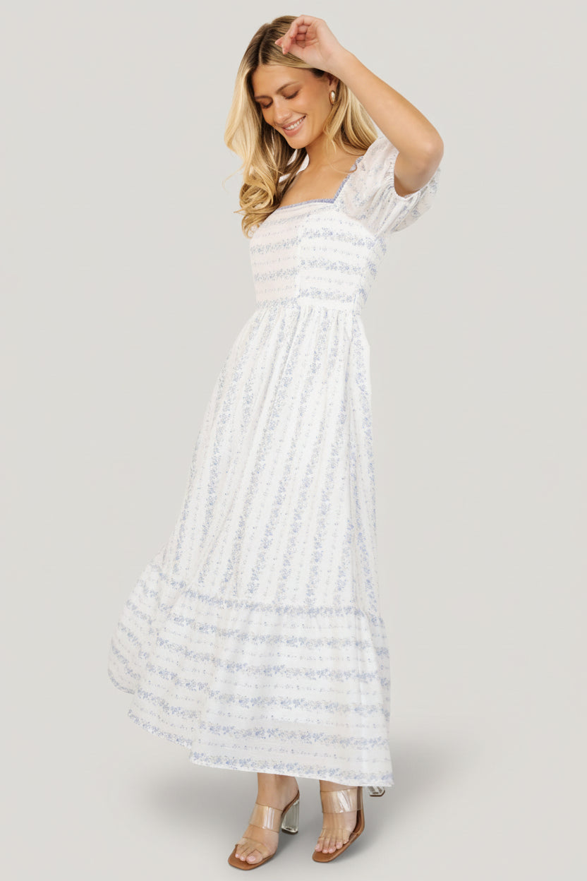Back view of Martine Puff Sleeve Midi Dress showing smocked back bodice and left-side zipper for an adjustable, secure fit.