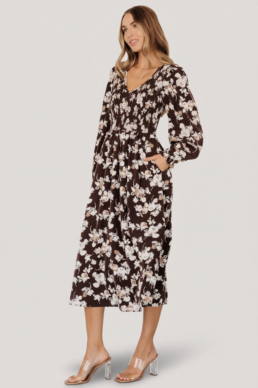 Side view highlighting hidden side pocket and fully lined midi skirt with soft drape in brown floral pattern.