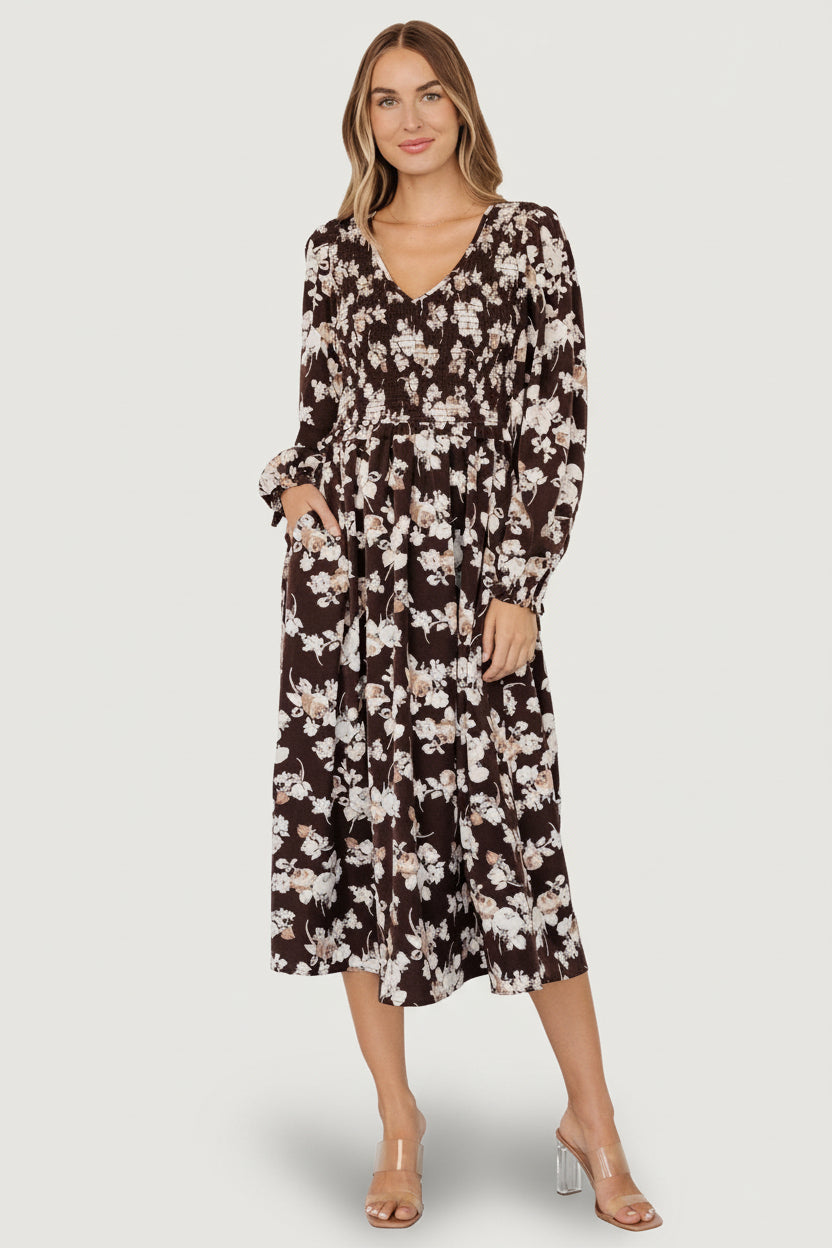 Sleeve detail showing puffed sleeve, elastic cuff and small ruffle in brown floral woven fabric.