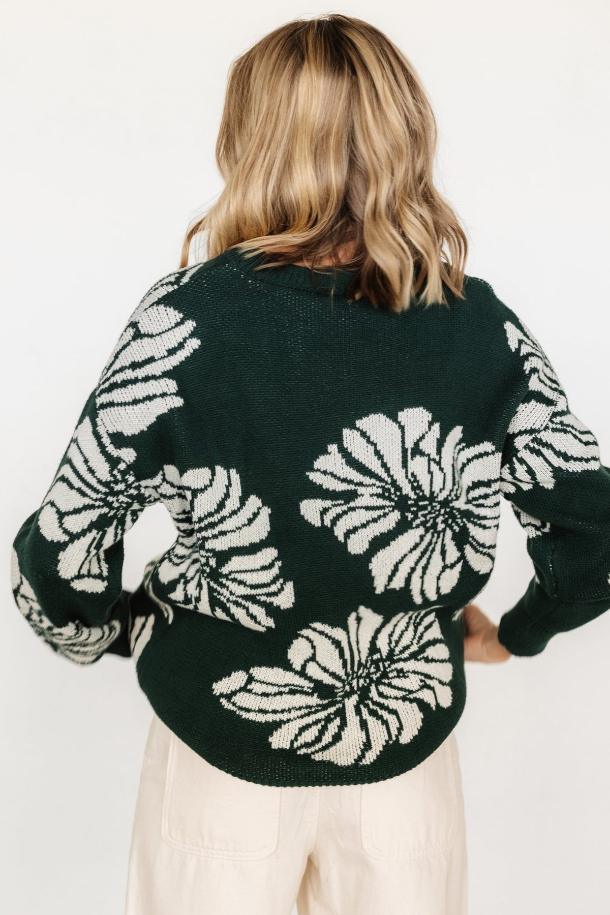Back and sleeve view of Maude oversized sweater emphasizing wide ribbed neckline, cuff and hem along with the large-scale floral design.