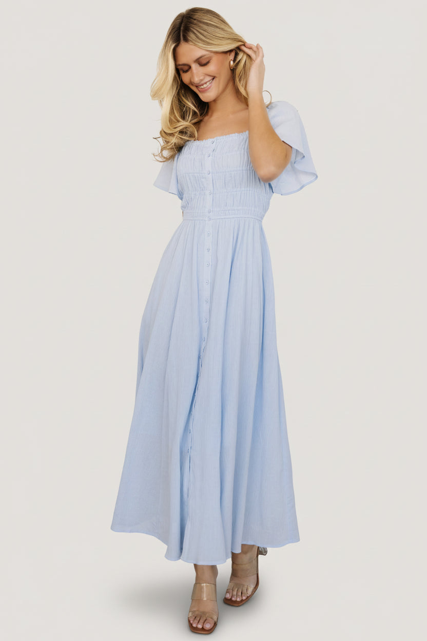 Close-up of textured crepe fabric and functional front buttons on the McKay maxi dress, showing fabric detail.