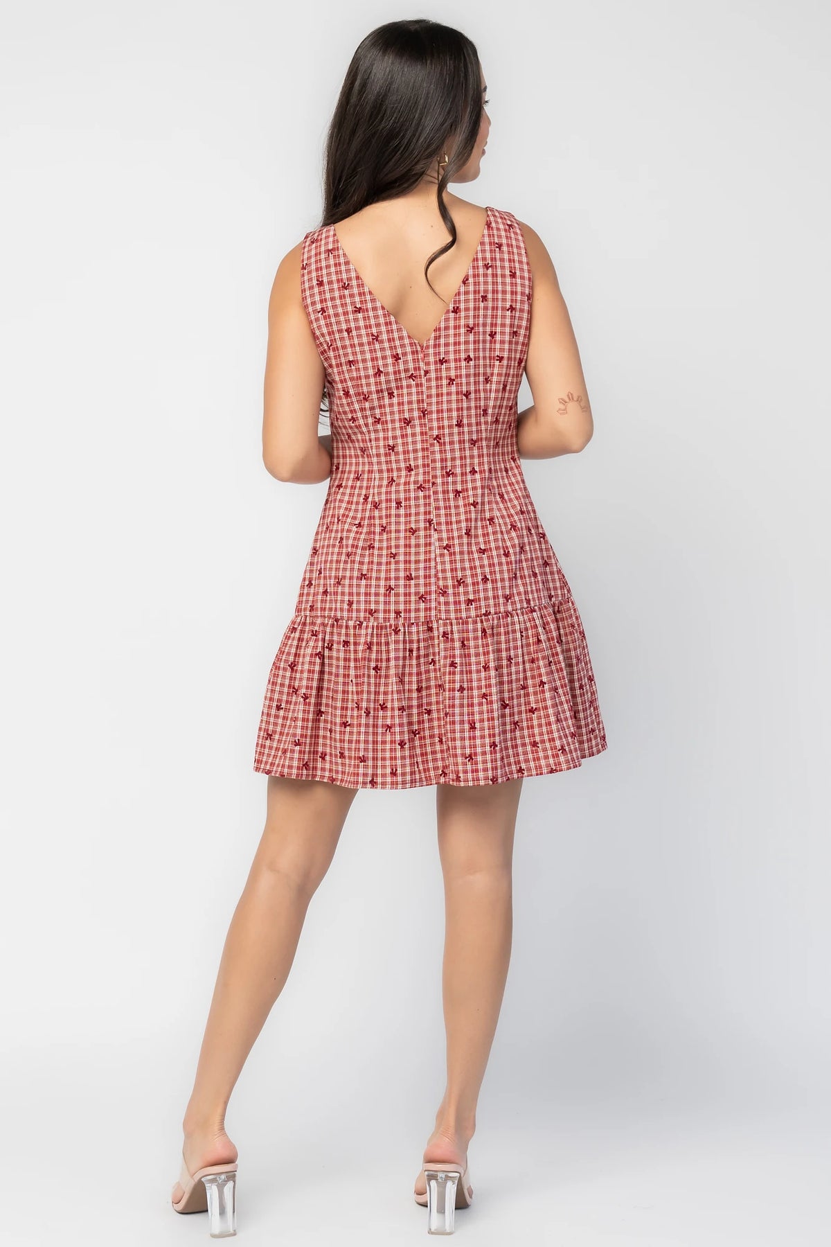 McQueen Short Dress in Red Gingham with bow details, sleeveless fitted bodice, drop waist, and ruffled short skirt.