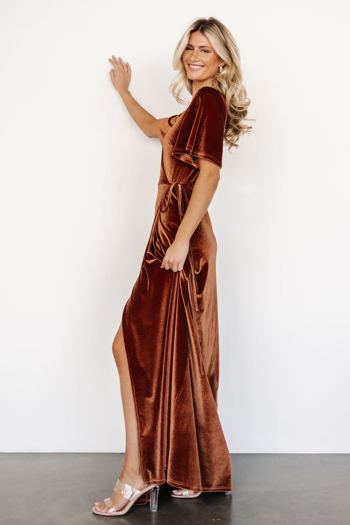 Back view of the spice velvet maxi dress displaying a smooth silhouette and long tulip hem for graceful movement and coverage.