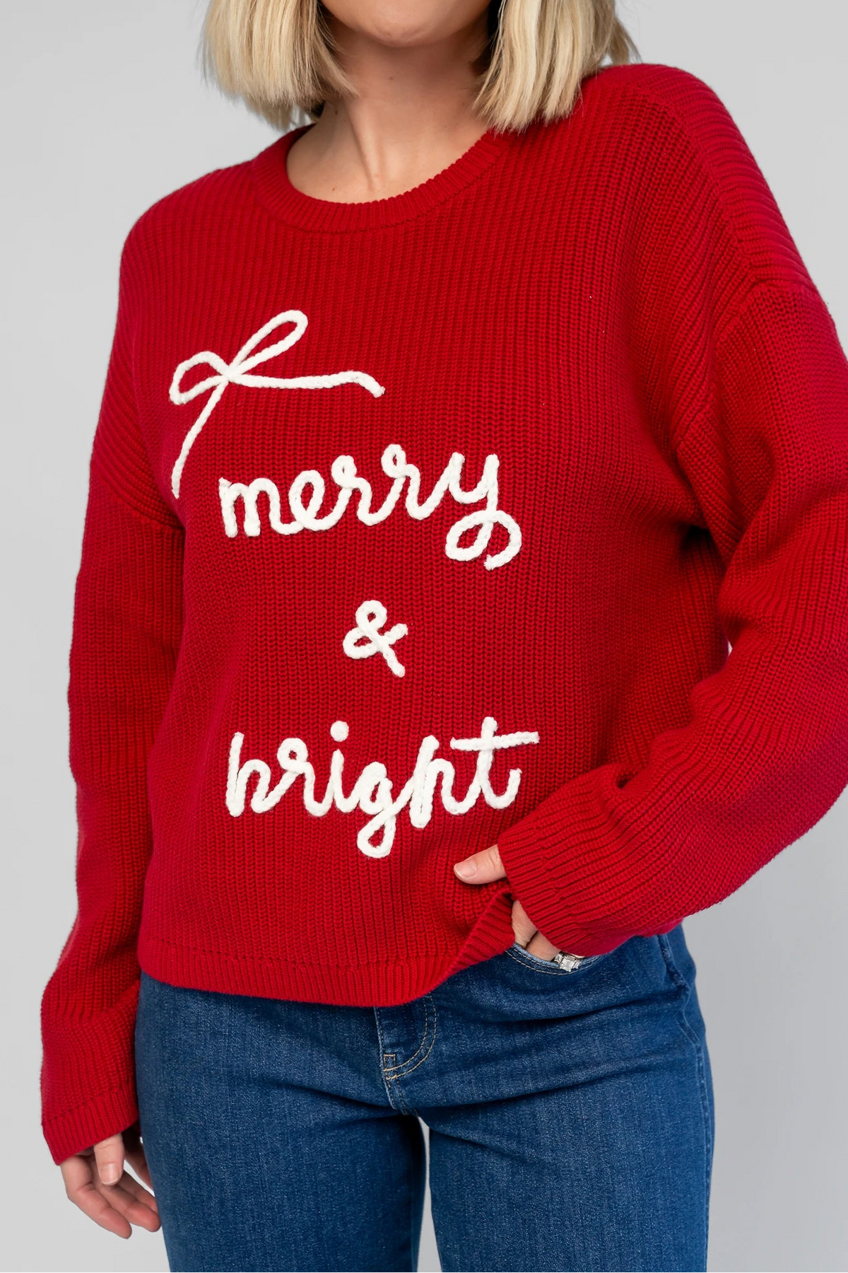 Merry Sweater in Red + Off White with a crew neckline, soft knit fabric, and embroidered Merry & Bright graphic.