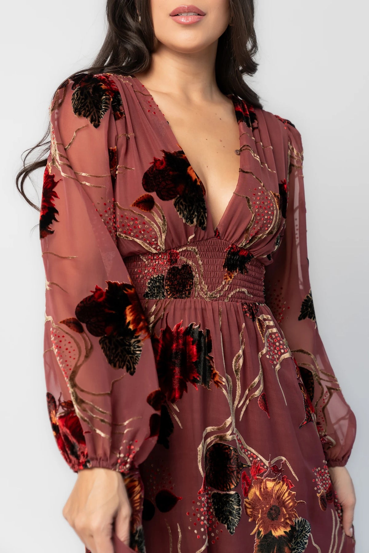 Mikla Maxi Dress in Berry Multi with burnout velvet print, deep V-neckline, long sleeves, smocked waist, and asymmetrical hem.