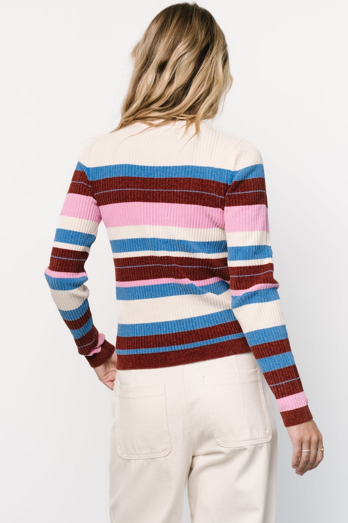 Close-up of velvet-knit fabric and stripe pattern in orchid, blue, cream, and burgundy showing texture and stitch detail.
