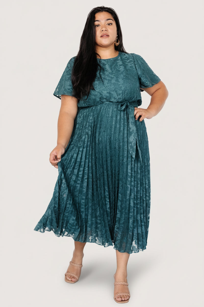 Close-up of dress bodice highlighting faux floral applique, round neckline with keyhole closure, and delicate chiffon texture.