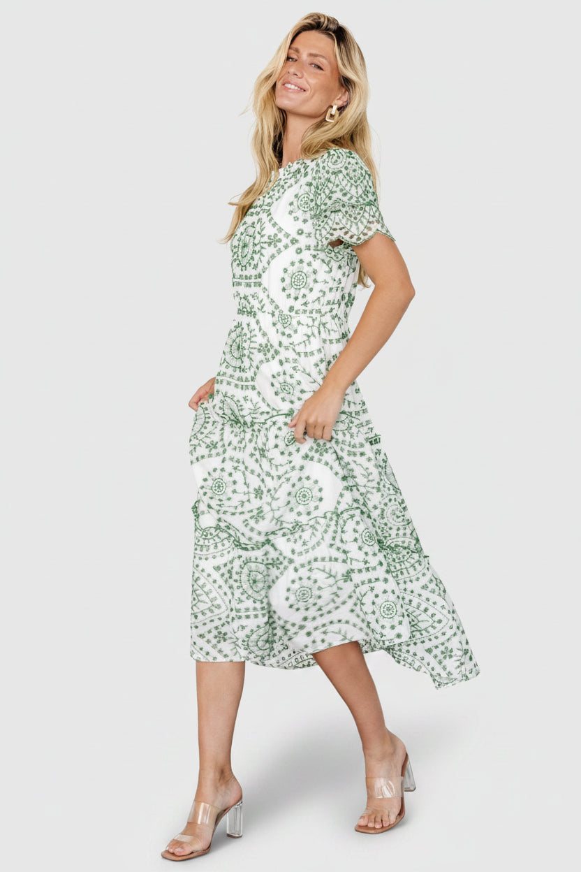 Back view of Mirabel dress showing keyhole and button closure, ruffle neck detail, and the fully lined bodice.