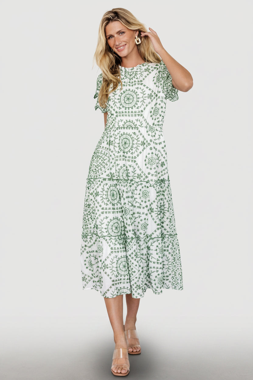 Front view of Mirabel embroidered eyelet midi dress in white with Kelly green eyelet, ruffled high neckline and tiered skirt detail.