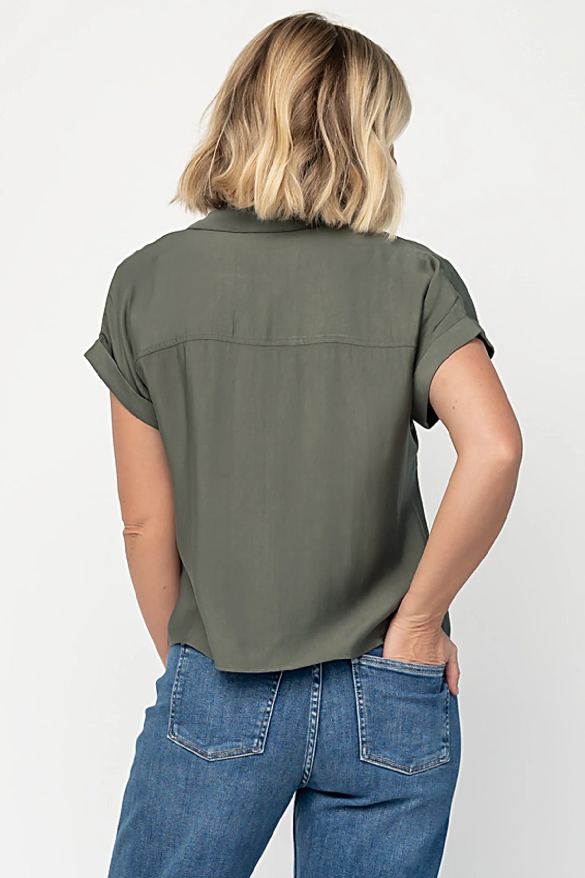 Miriam Top in Dark Sage with collared neckline, concealed button front, cuffed short sleeves, and relaxed silhouette.