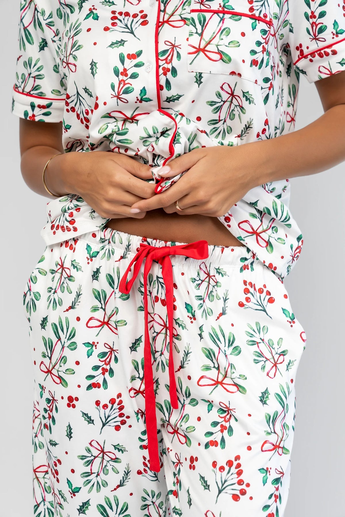Mistletoe Cozy Pajama Set in Ivory Multi with a festive mistletoe and holly print, button-front top, and contrast piping.