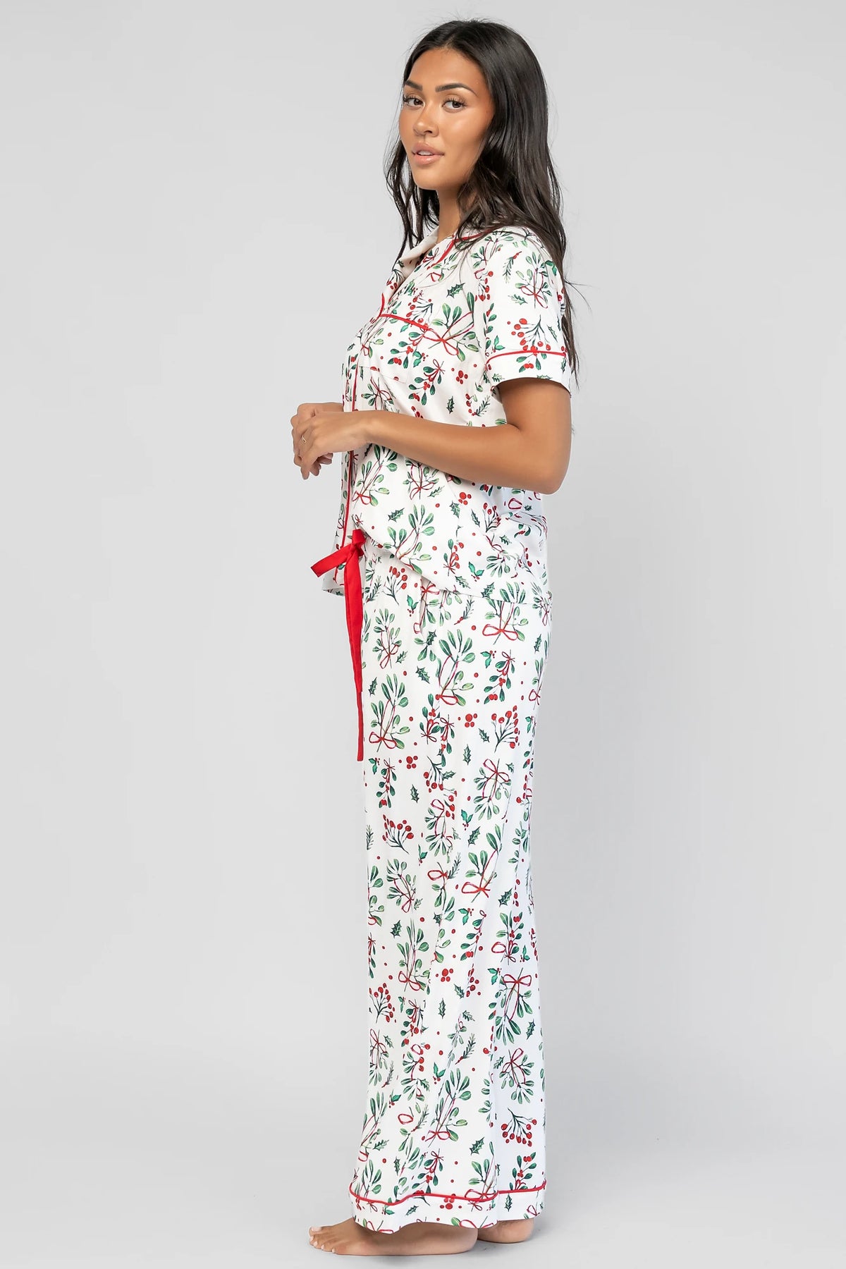 Mistletoe Cozy Pajama Set in Ivory Multi with a festive mistletoe and holly print, button-front top, and contrast piping.