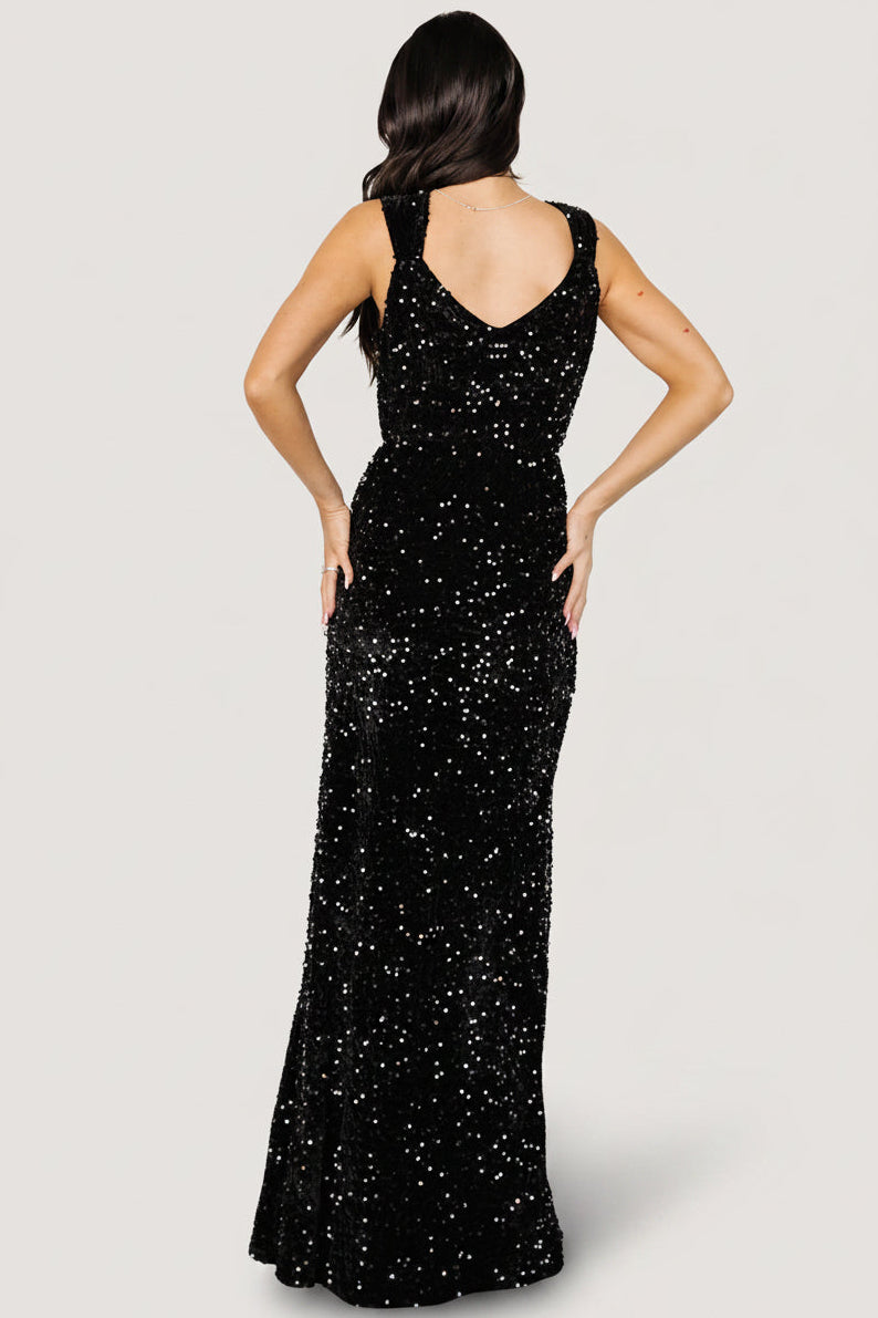 Side view of Monroe sequin gown emphasizing the left-side leg slit, elastic waistband and the way the gown moves with each step.