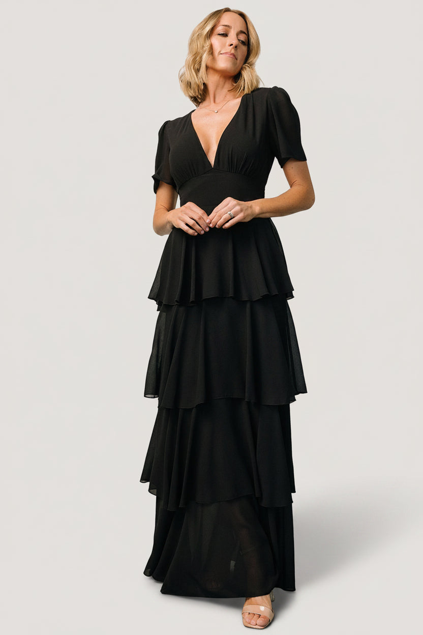 Styled shot of the black Montaigne ruffle maxi dress paired with simple accessories to showcase its versatile occasion-ready look.