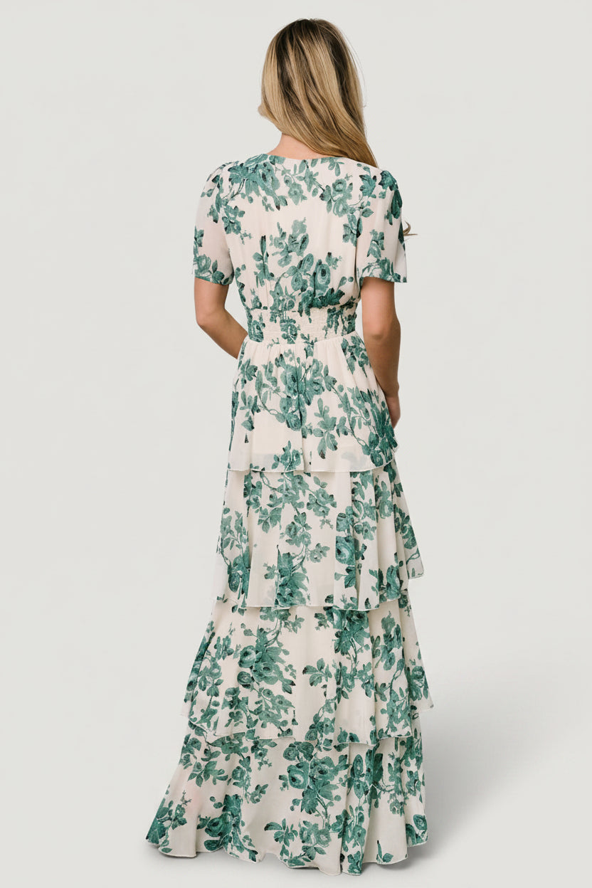 Full-length studio shot of the ivory floral maxi on model, showing overall silhouette, ruffles, and sleeve shape.
