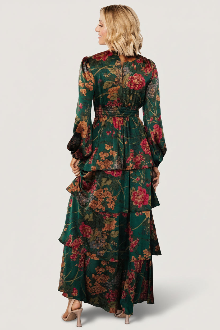 Back view of emerald floral maxi dress showing smocked back panel and how the fabric gathers at the waist for a comfortable fit.