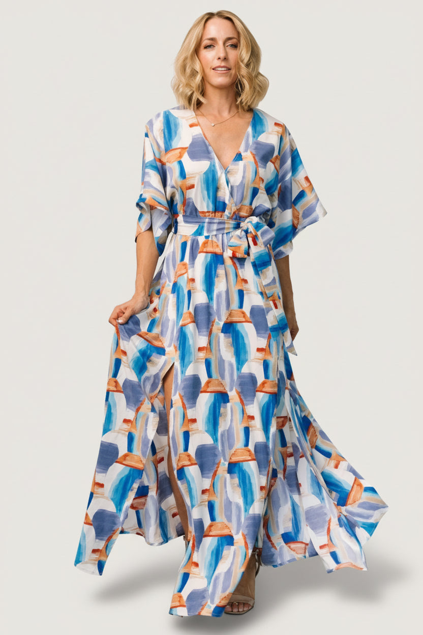 Close-up of wide cape sleeve and shoulder drape in sky blue and periwinkle brushstroke print fabric.