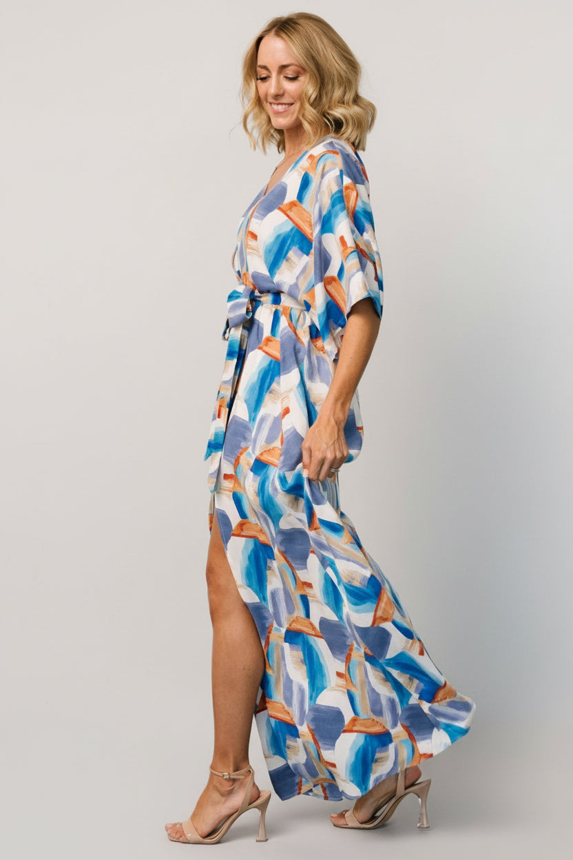 Detail of removable sash tied at the elastic waist, showing brushstroke pattern and lightweight woven polyester texture.