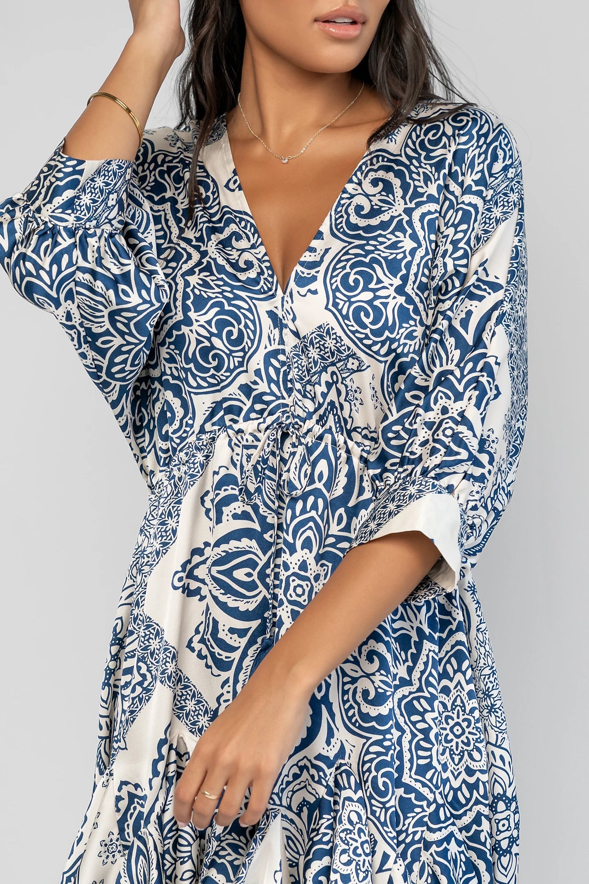 Morwen Short Dress in Navy Print with a V-neckline front and back, batwing sleeves, and a ruffled paneled skirt.