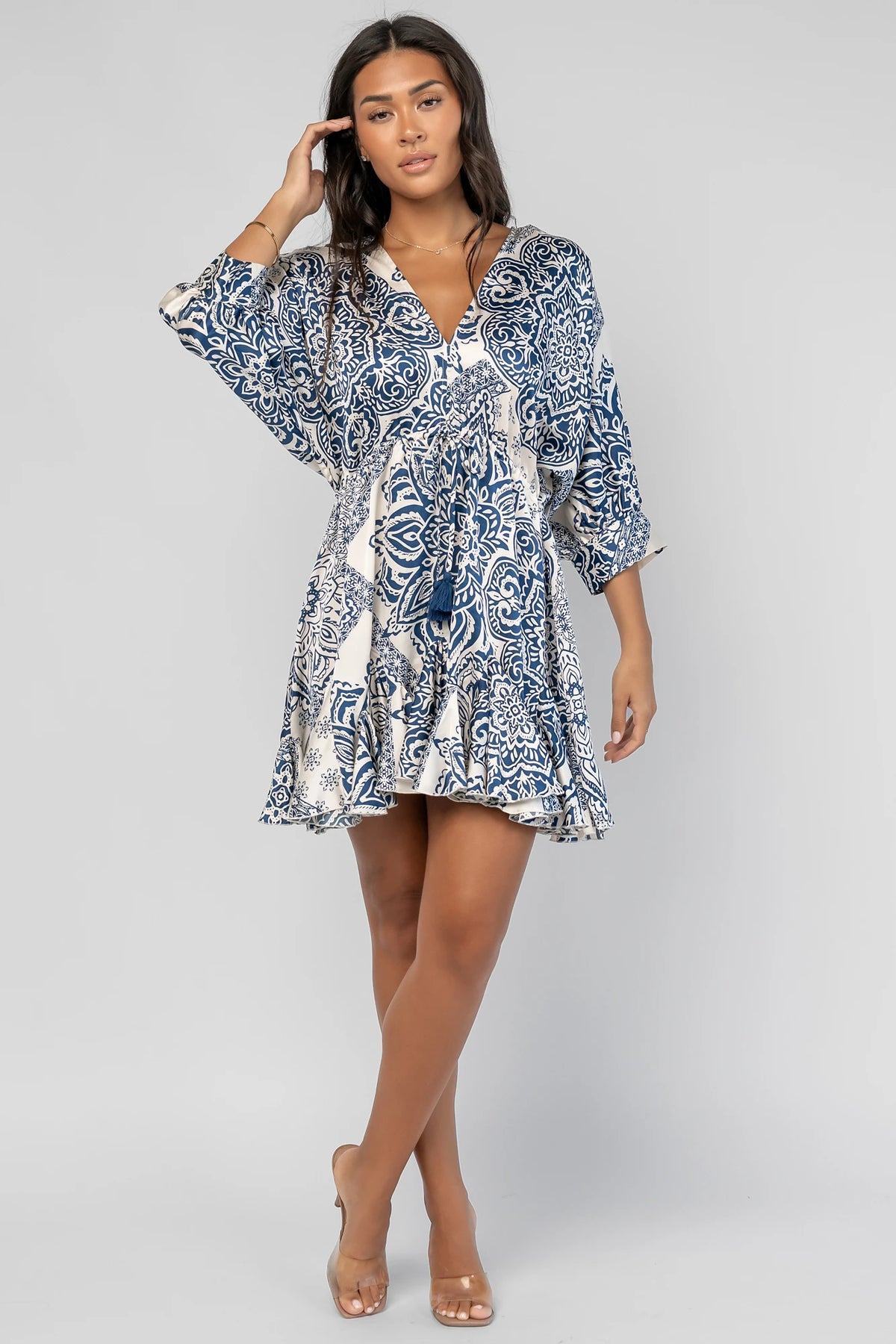 Morwen Short Dress in Navy Print with a V-neckline front and back, batwing sleeves, and a ruffled paneled skirt.