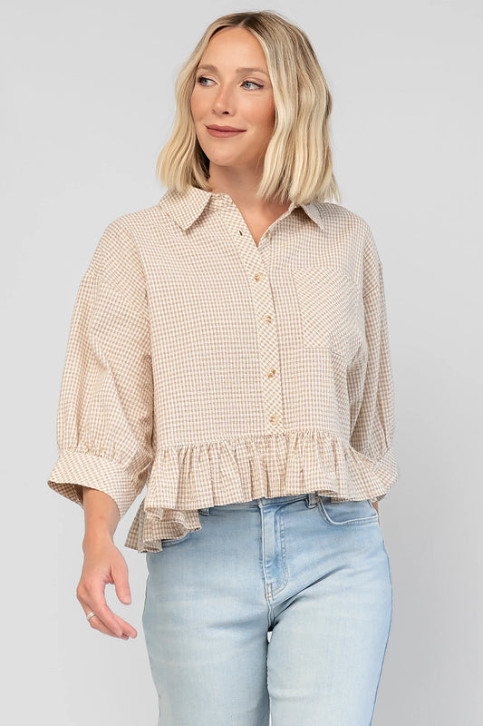 Murphy Relaxed Peplum Top in Beige with a collared neckline, button-front closure, chest pocket, and peplum hem.