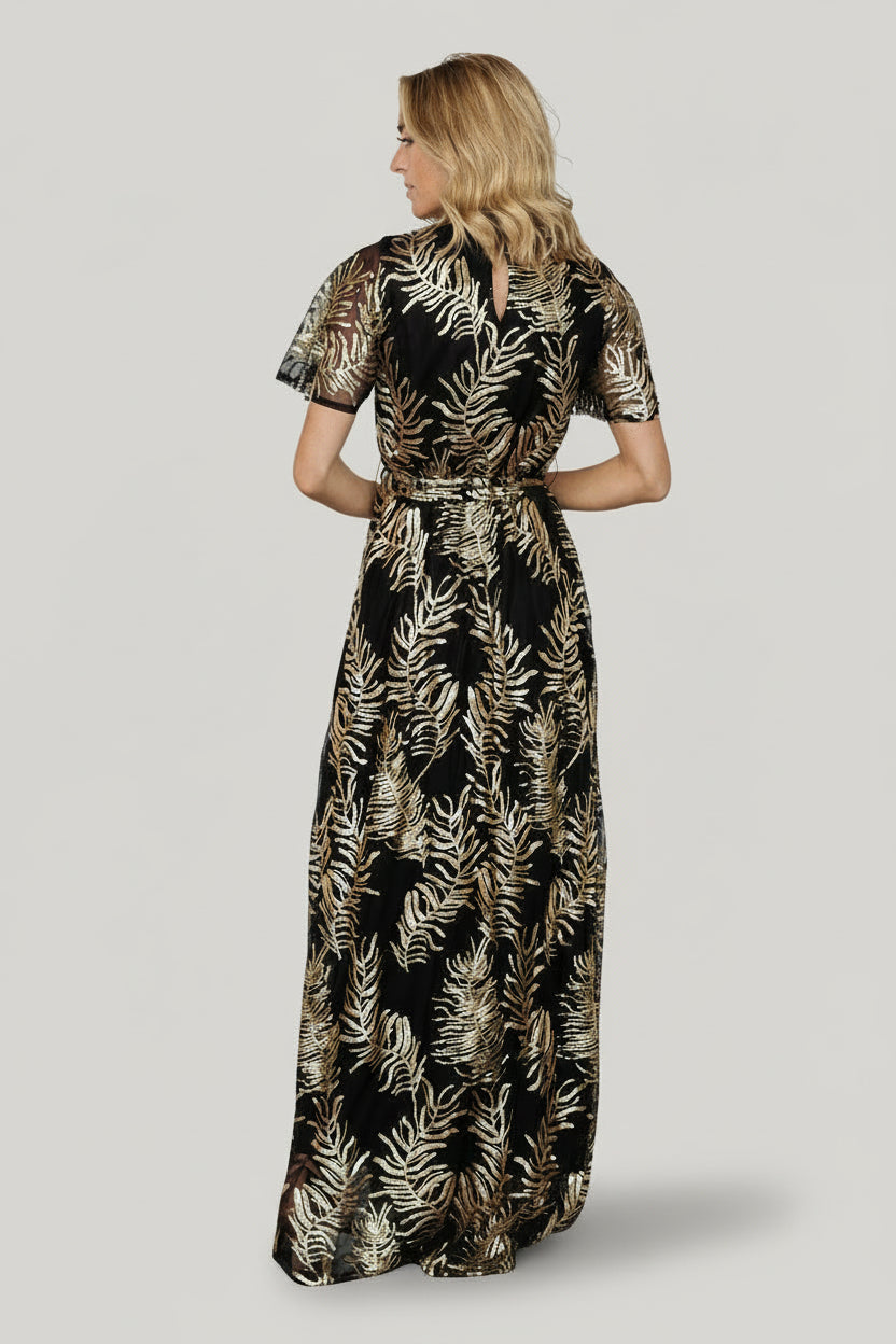 Model photo highlighting round neckline, fitted bodice, and contrast between lined body and sheer sequin sleeves for evening wear.