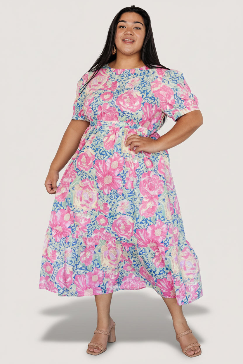 Back view of the midi dress showing the keyhole with button closure, elasticated waist shaping, and skirt tier detail.
