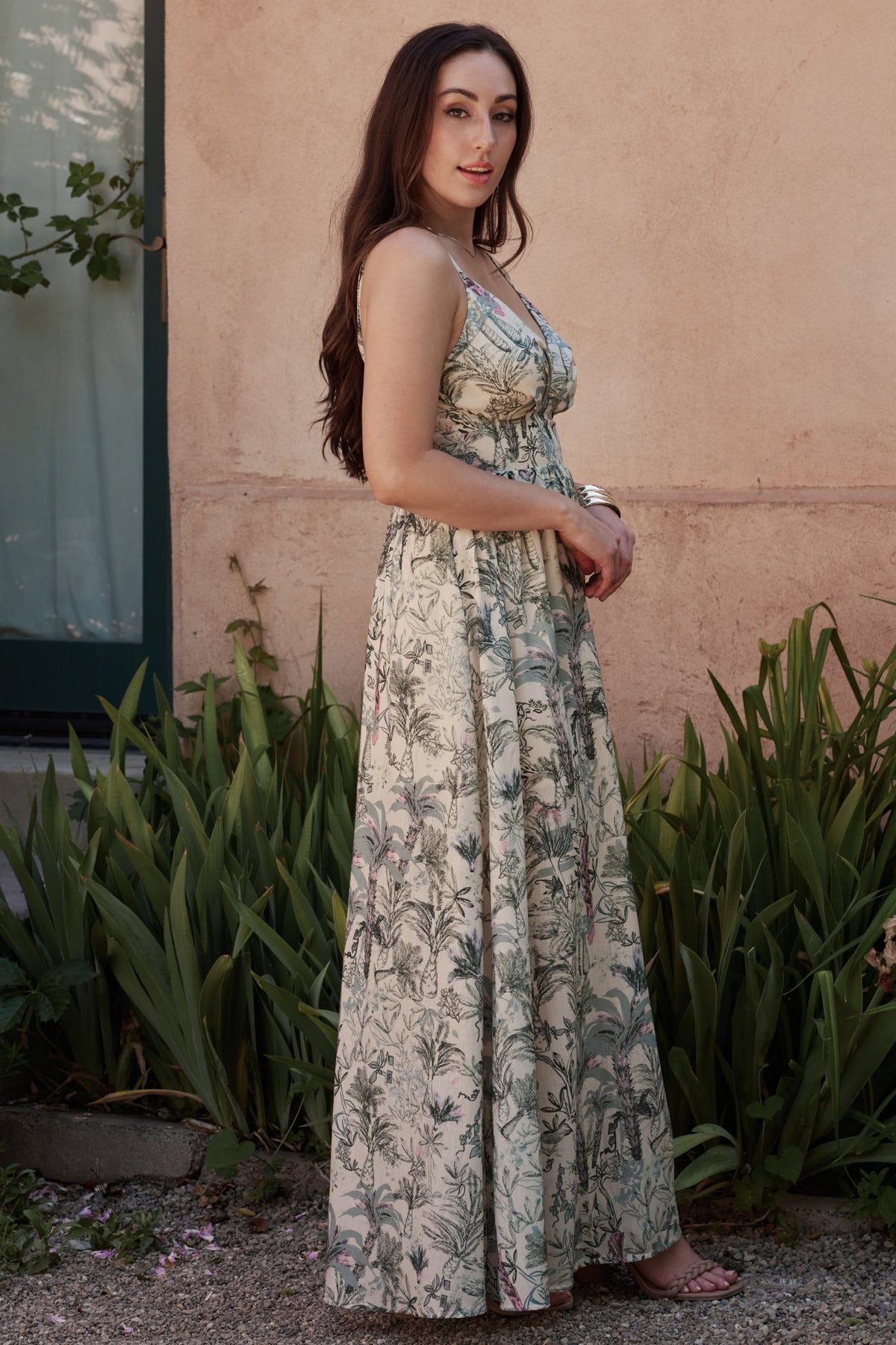 Close-up of the Naia Maxi Dress bodice highlighting up-pointed paneled design, gathered bust, and deep V-neck in sage tropical print.