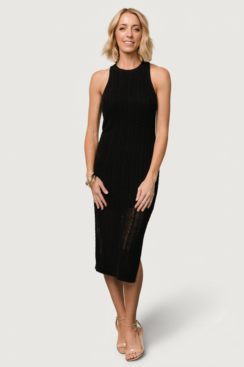 Front view of Nalani Knit Tank Dress in black on model, showing open cable knit, round neckline, sleeveless sheath and knee-length lining.