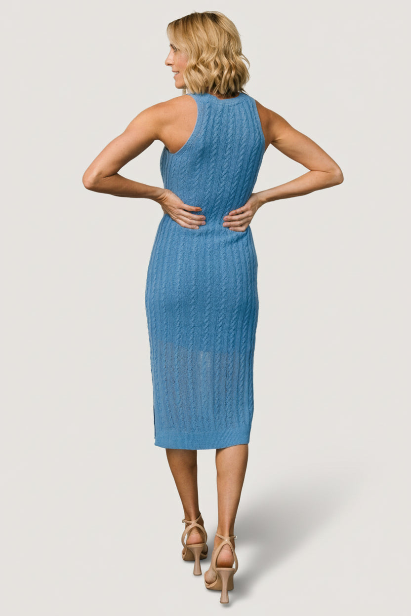 Model wearing the Nalani knit tank dress in bold blue, styled with minimal accessories to show fit and length just below the knee.
