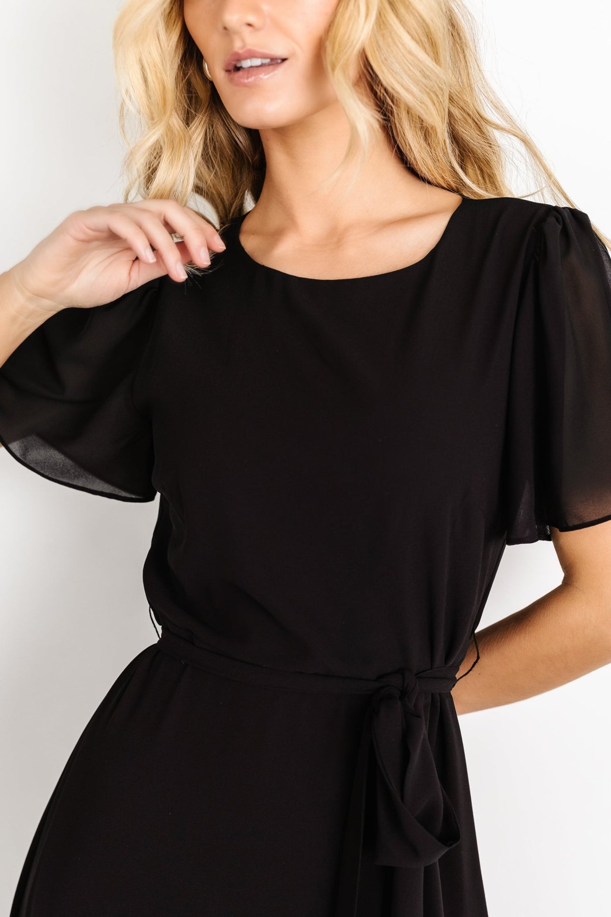 Full-length shot of black chiffon Naomi dress on model, showing maxi length, skirt sweep, and formal silhouette.