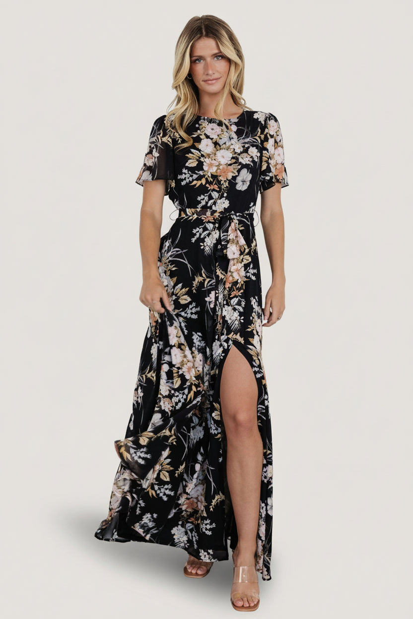 Left-side view highlighting the maxi skirt’s left leg slit and flowing sweep for ease of movement and an elegant line.