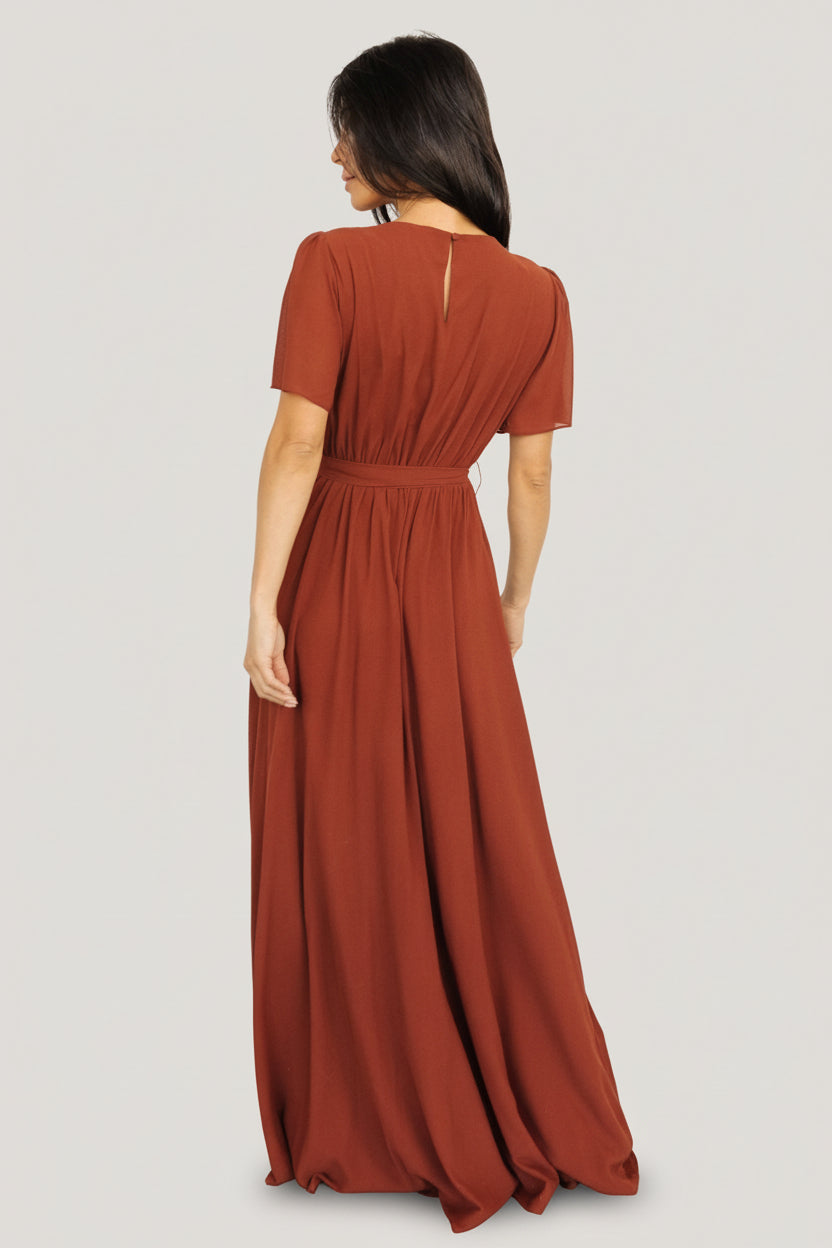 Back view of Naomi cinnamon chiffon maxi dress showing keyhole with button closure and elastic back waist detail.