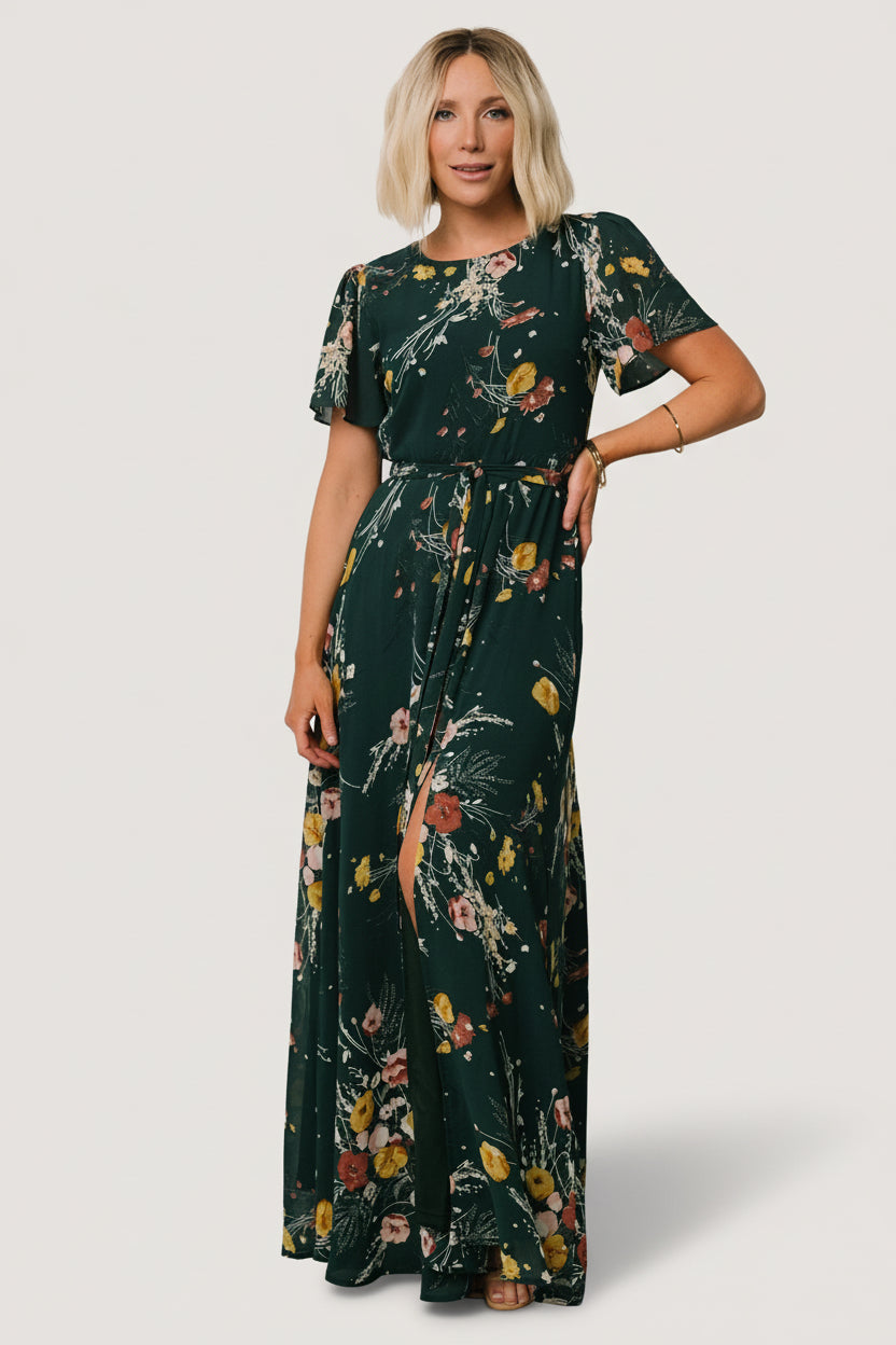 Styled outfit photo of dark green floral chiffon maxi dress paired with neutral sandals, showing relaxed yet elegant look.