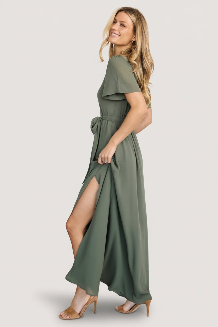 Model styling photo of Naomi short sleeve chiffon maxi dress in dark sage paired with accessories to show formal occasion styling options.