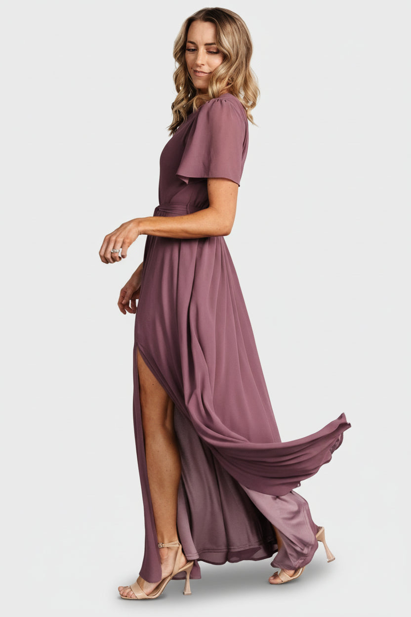Detail shot of short flutter sleeve and stitched hem on the Naomi chiffon maxi dress in vintage plum, showing fabric drape and finish.