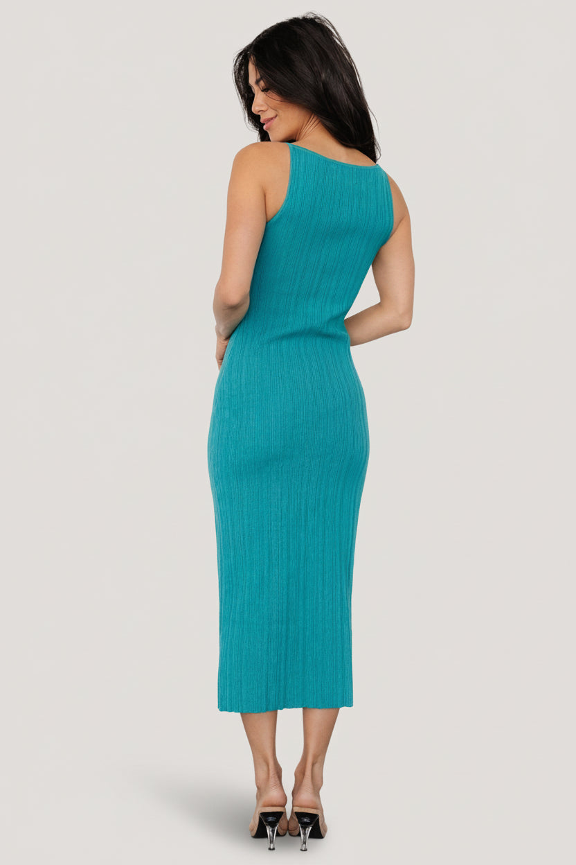 Teal Natia tank dress styled with sandals on model, showing overall fit, midi length, and raw hem detail for everyday wear.