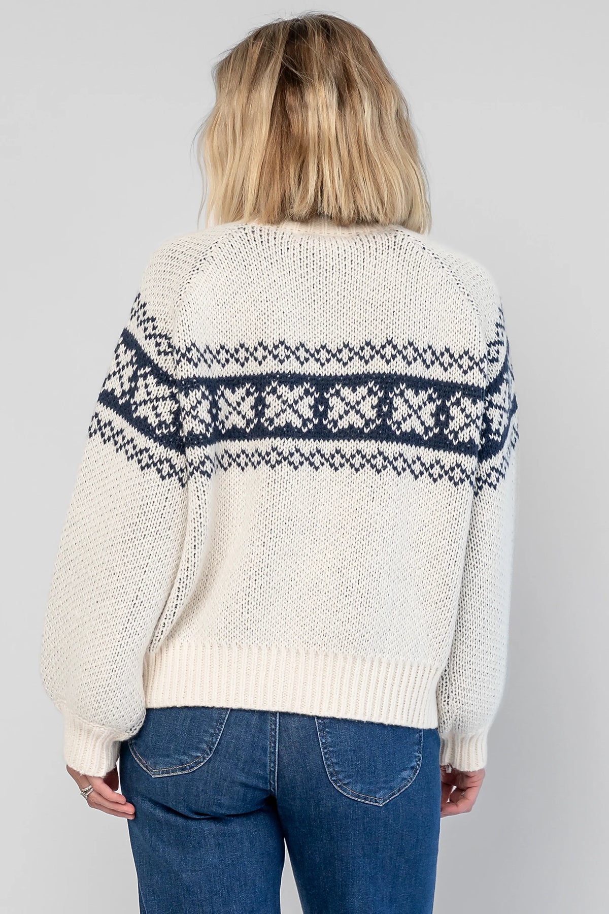 Neve Sweater Jacket in Cream + Navy with a Fair Isle knit pattern, turtleneck, silver zip-front design, and cozy thick knit.