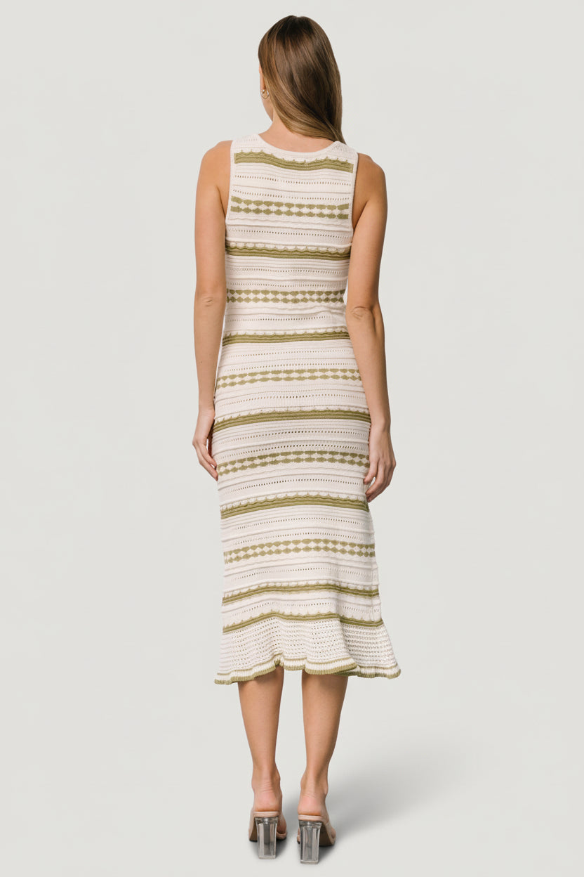 Model walking in cream and sage pointelle midi dress, showcasing movement, relaxed fit, and casual beach-to-market styling.