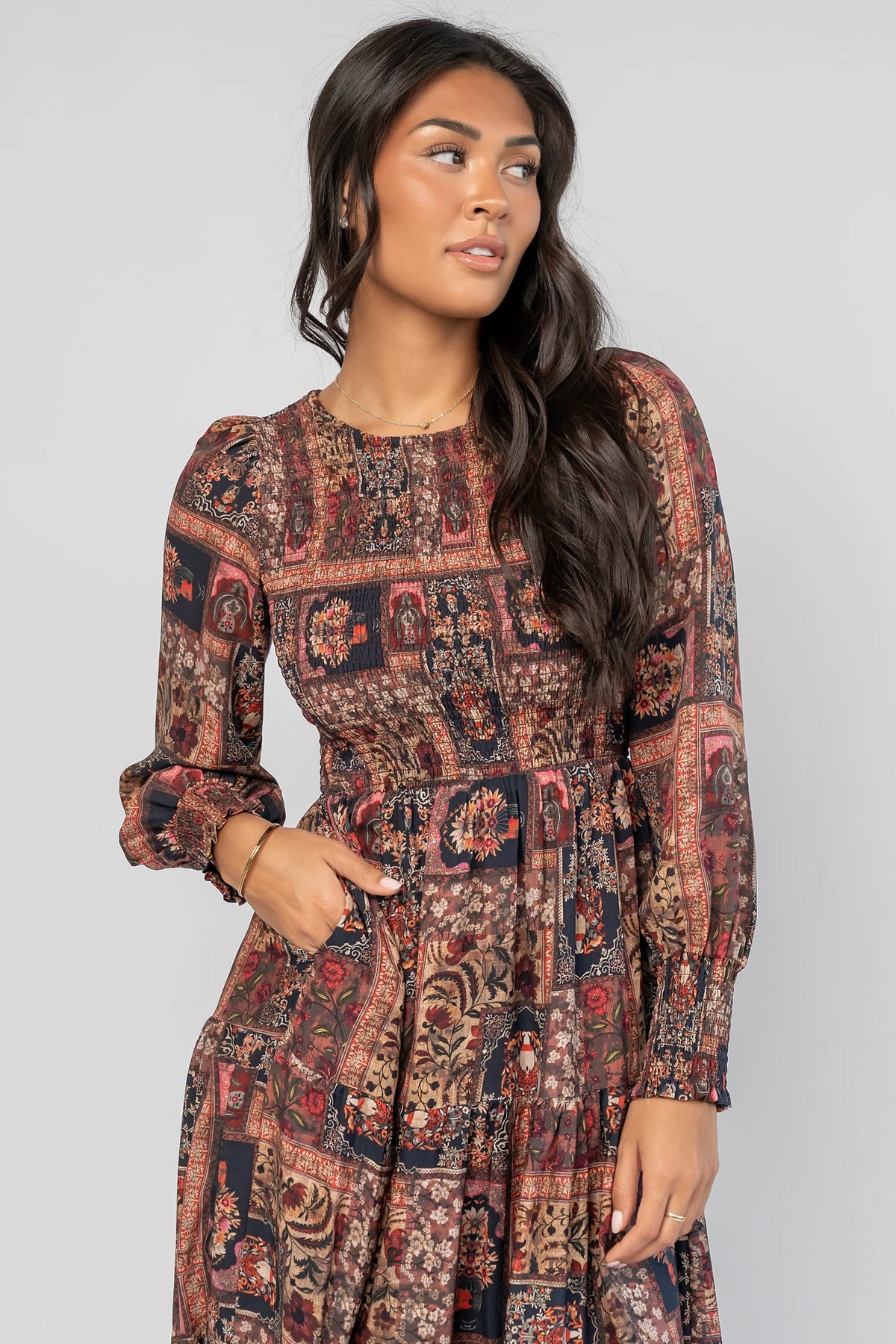 Nikki Smocked Midi Dress in Multi Print with a round neckline, smocked bodice, smocked cuffs, and a tiered skirt.