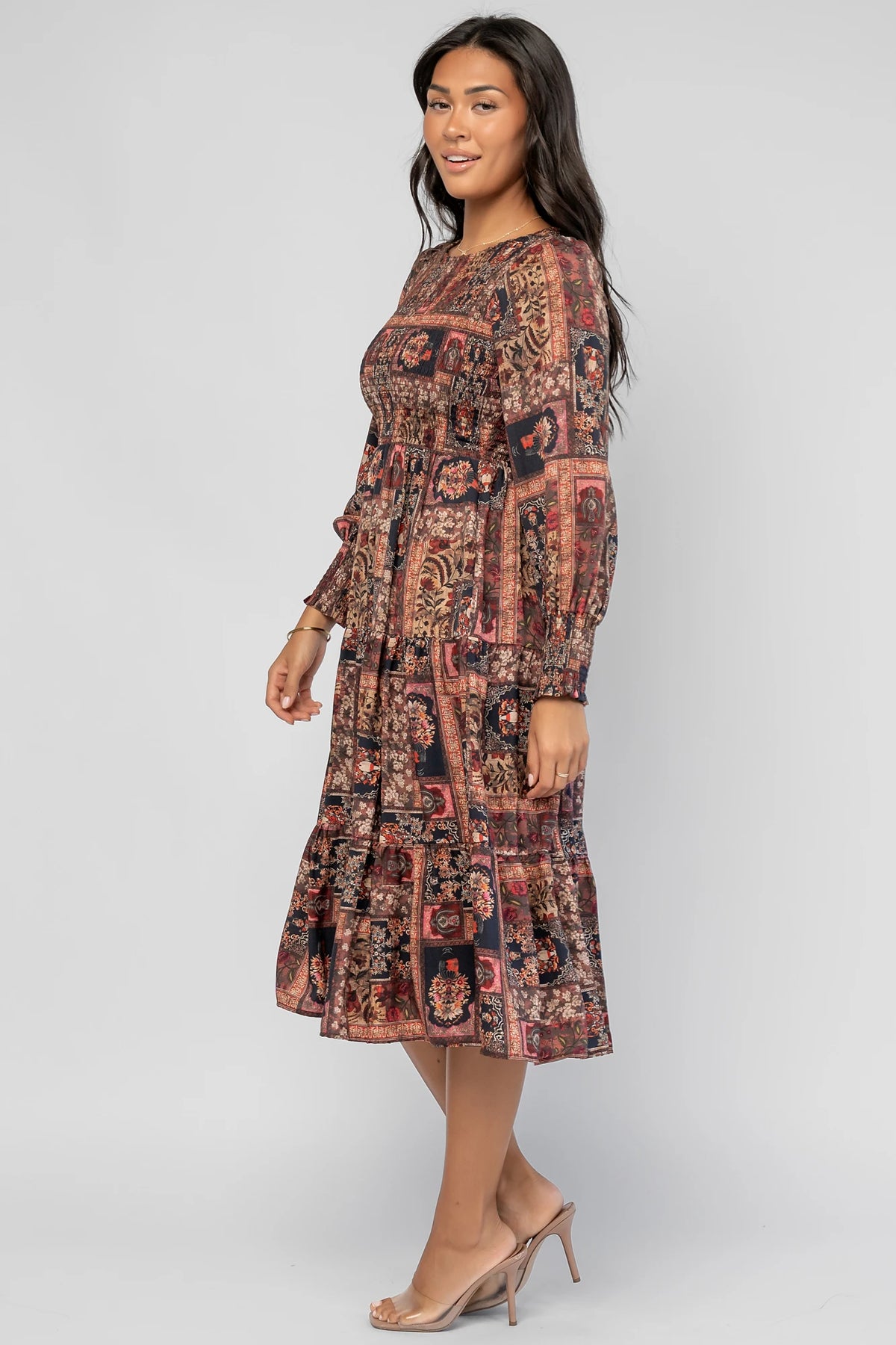 Nikki Smocked Midi Dress in Multi Print with a round neckline, smocked bodice, smocked cuffs, and a tiered skirt.