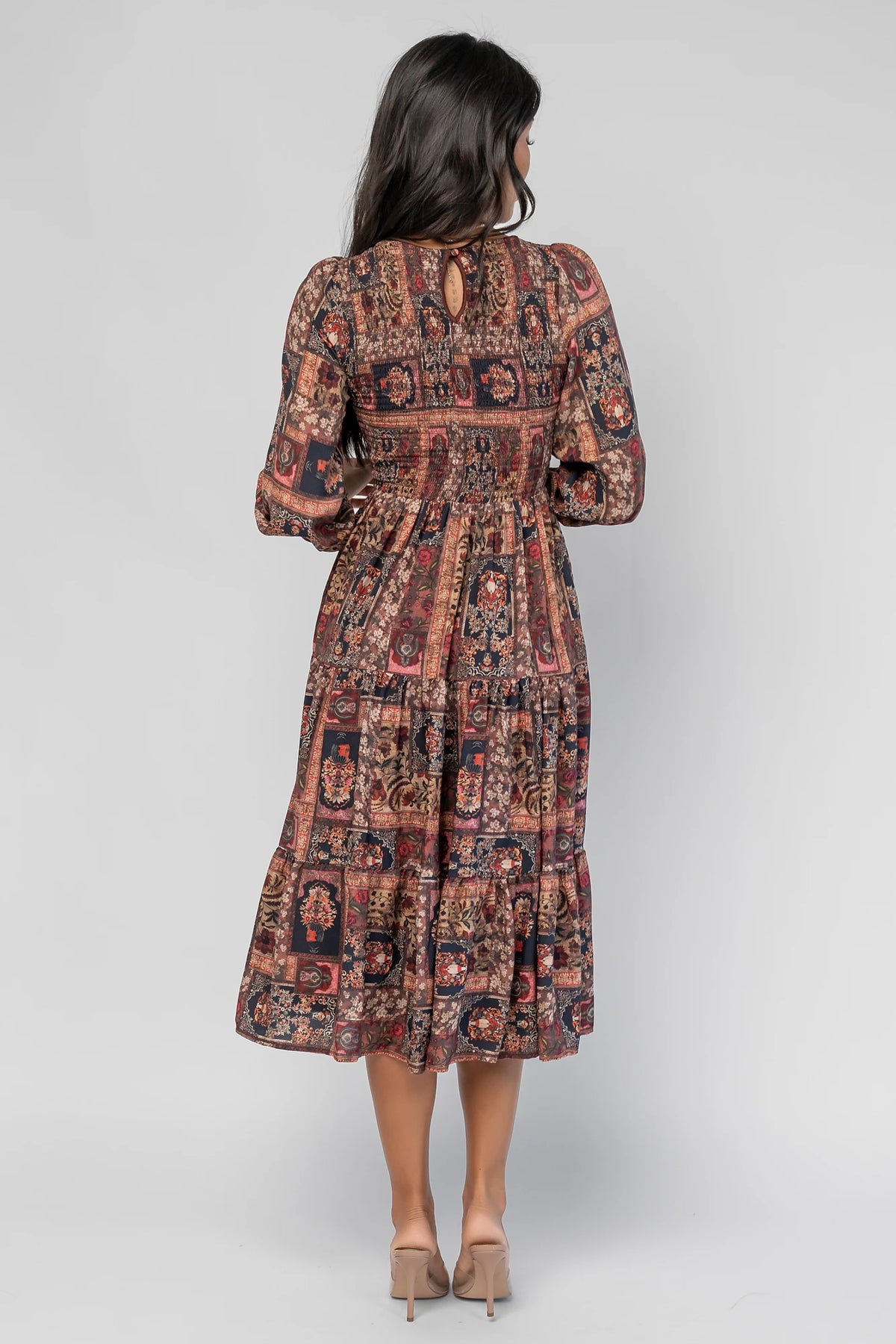 Nikki Smocked Midi Dress in Multi Print with a round neckline, smocked bodice, smocked cuffs, and a tiered skirt.